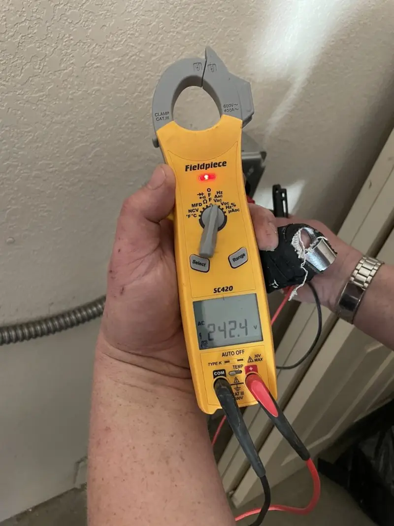 Voltage testing with clamp meter during Generator Installation in Osawatomie